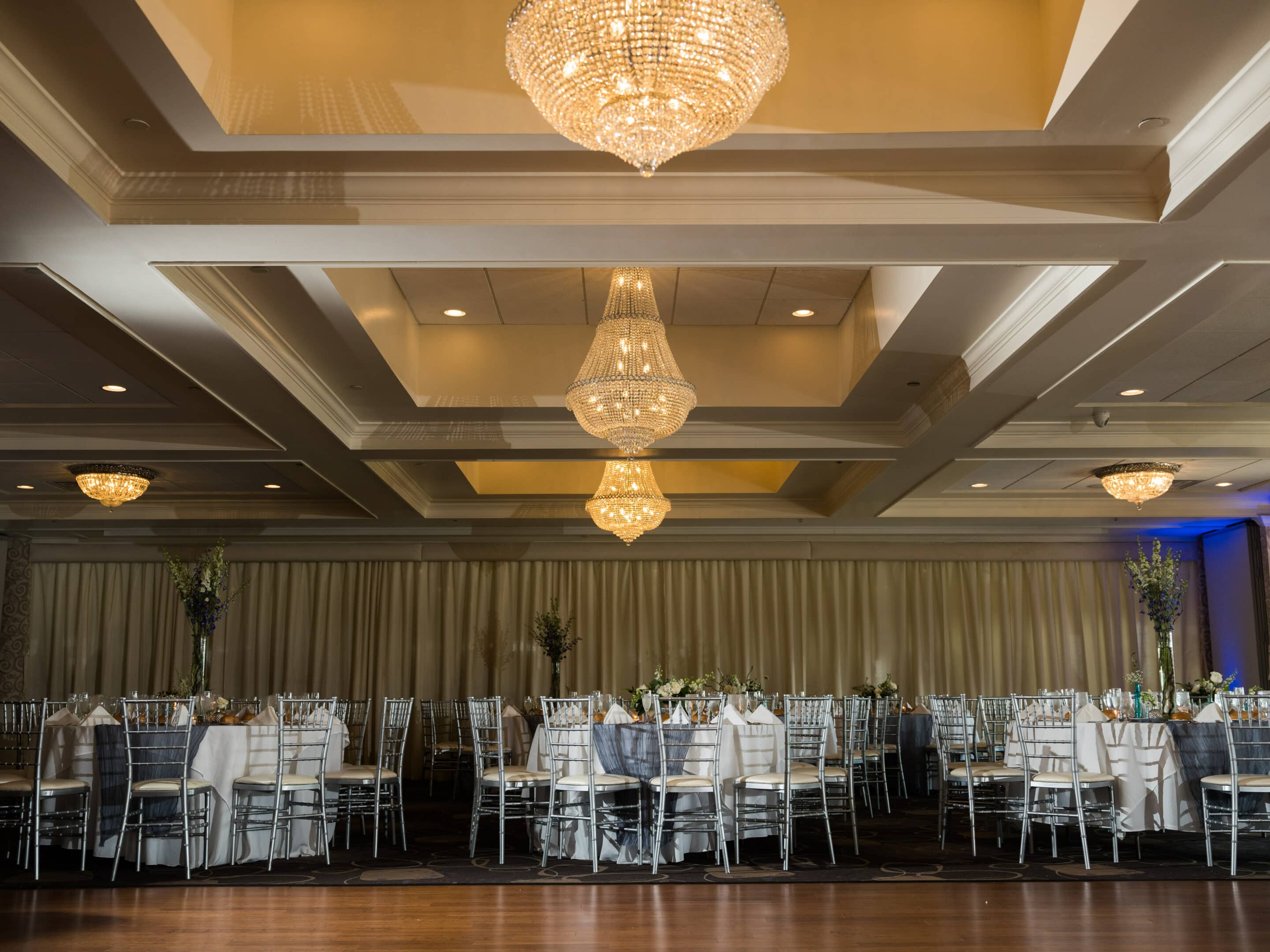banquet room with tables and chandeliers
