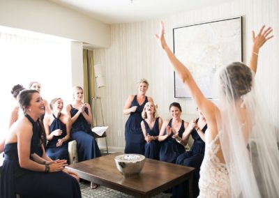 Bride and bridemaids getting together in a hotel room before the wedding ceremony.