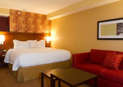 Courtyard Marriott room showing bed, couch, and coffee table.