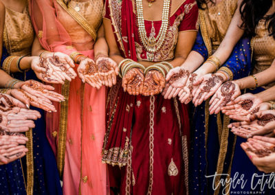 Multicultural wedding with bridal group showing their hand tattoos.