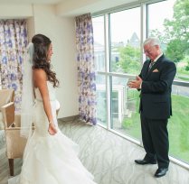 A bride and her father preparing in the Courtyard Marriott