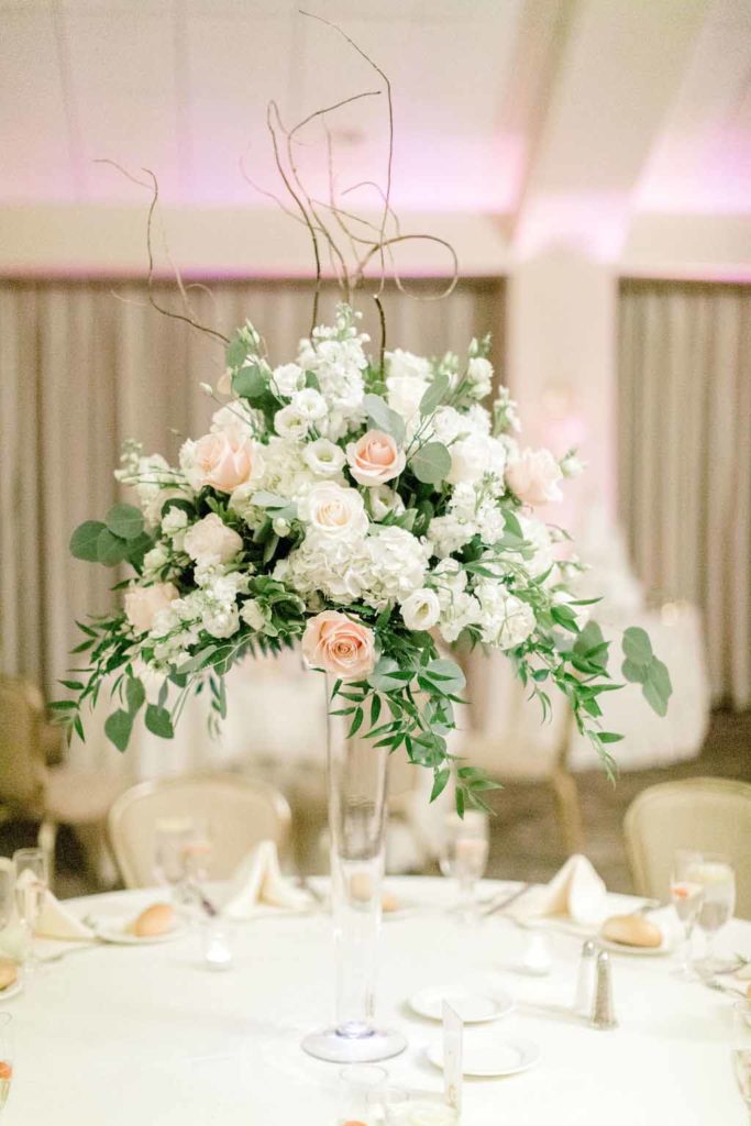 Bouquet of flowers on table in champagne and neutral colors. Photographed by: Kristina Elizabeth Photography