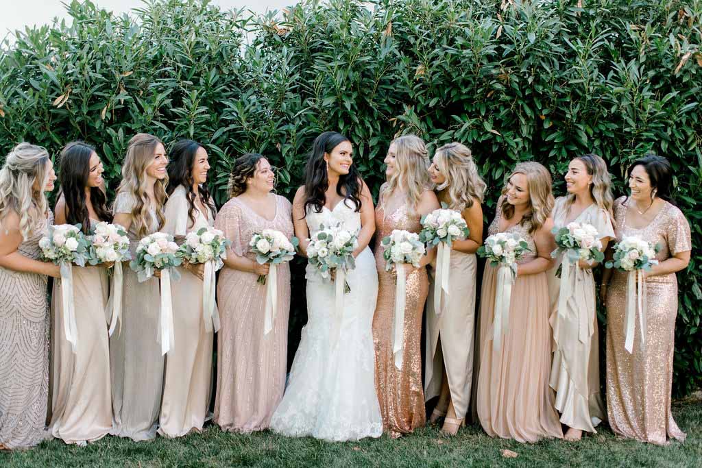 Bride in white with bridesmaids in Champagne and neutral colors. Photographed by: Kristina Elizabeth Photography