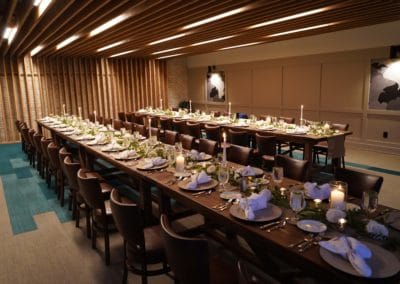 Private event room set with two long rectangular wooden tables.