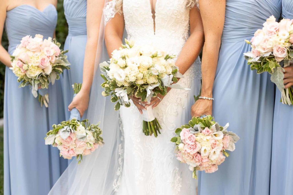 Bridesmaids wearing dusty blue gowns. Photographed by: Lisa Hornak Photography