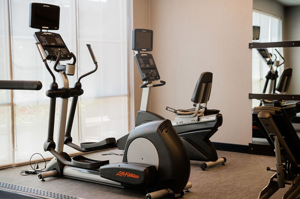 Marriot Gym featuring elliptical and reclining bicycle equipment.