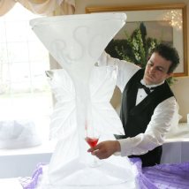 A member of our experienced event staff pouring wine from a hand carved ice Luge
