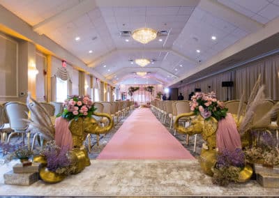 Indoor Indian wedding ceremony set up of aisle with pink décor in the Atrium