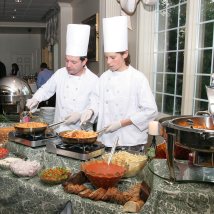 Members of our experienced culinary staff serving from the pasta bar