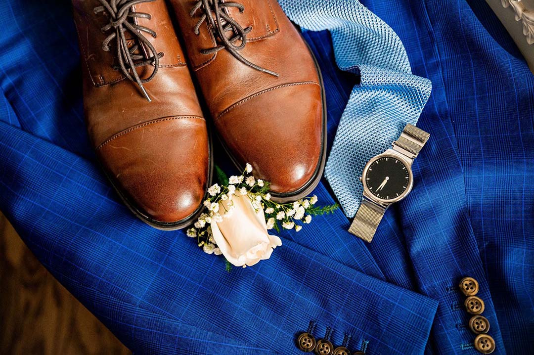 Grooms wedding attire, with shoes, watch, tie and jacket.