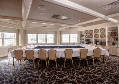 Reserve Room setup with table in rectangle format with all attendees facing each other. Showing the whole room.
