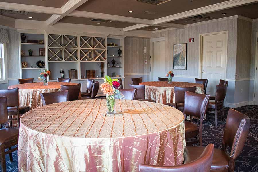 Reserve Room at Springfield Country Club decorated in tans and browns with round tables..