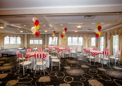 Salon 1 with tables set up with red and white strip design.