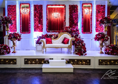 Wedding altar set up with couch and lots of red roses.