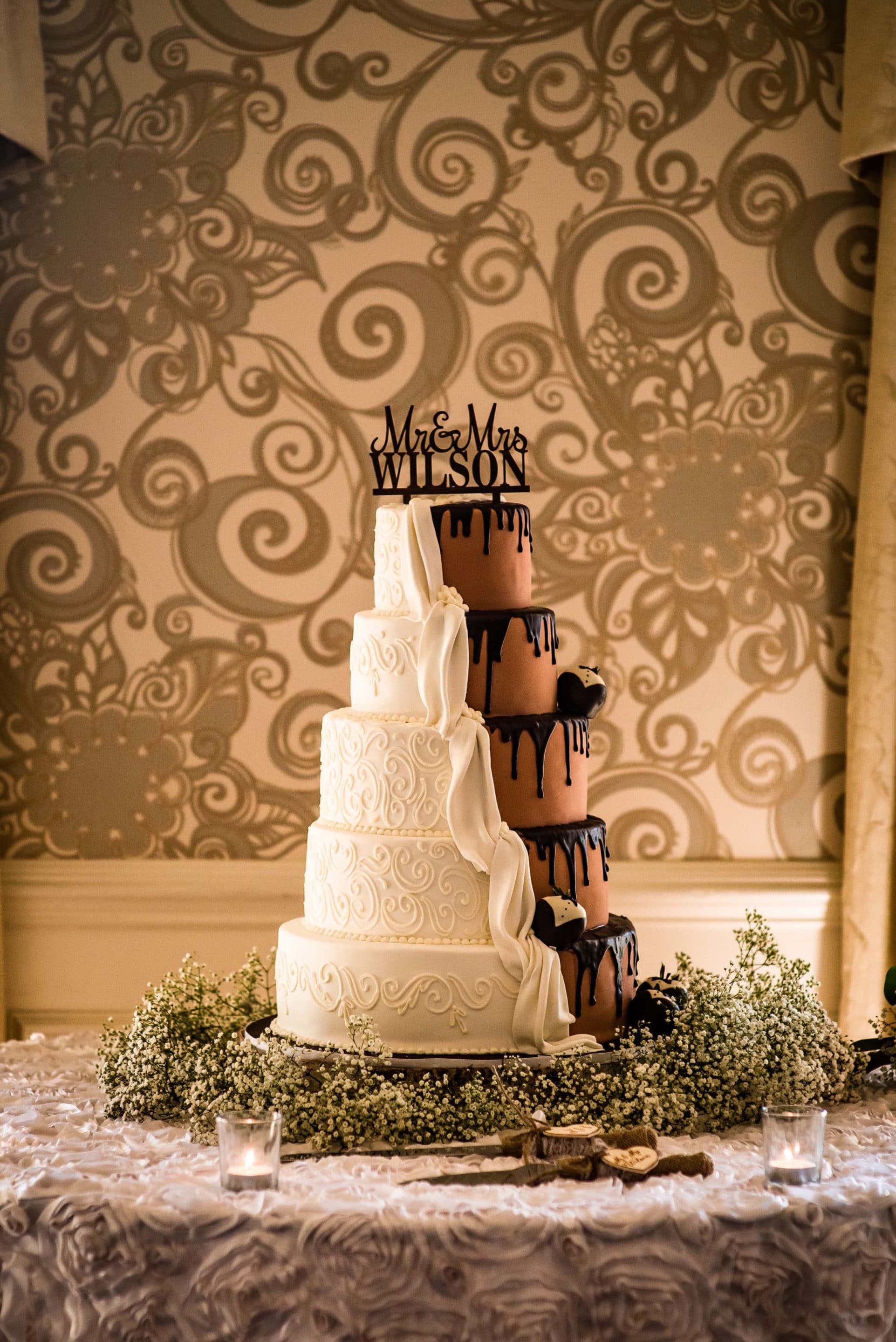 Five layer wedding cake with half white icing and half chocolate icing.